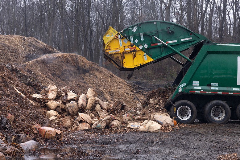 A truck delivers leaves to be composted at Ag Choice in Andover