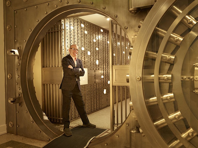 Developer Bob Silver stands smiling in a former safe-deposit vault inside what is now Grover House in downtown Caldwell