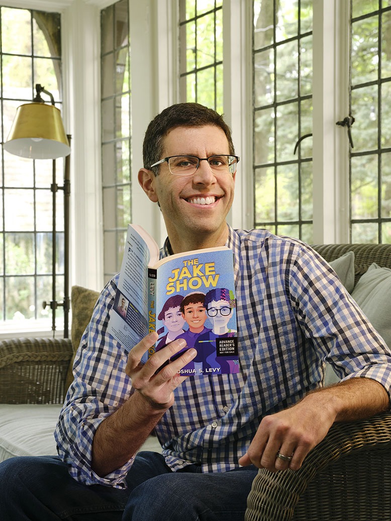 Joshua S. Levy holds a copy of his latest book, "The Jake Show"