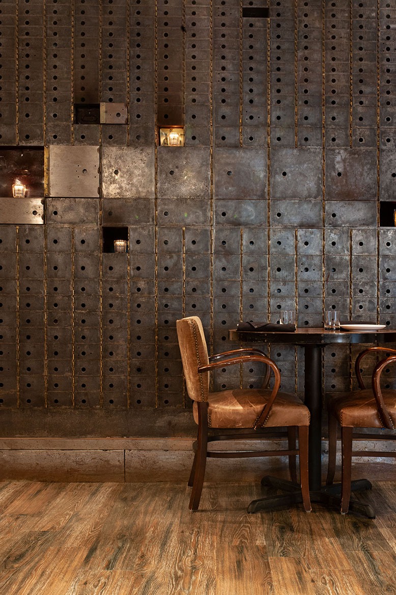 In a corner of Felina in Ridgewood, candles are set in a wall of former safe-deposit boxes
