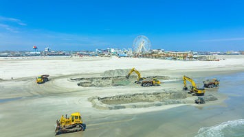 Trucks dig up sand in Wildwood to transport to North Wildwood