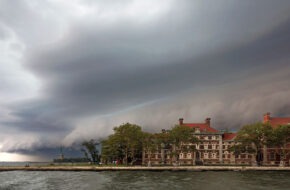 Exterior shot of Ellis Island's hospital complex in New Jersey amid dark rain clouds