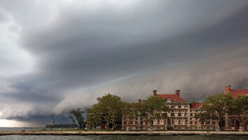 Exterior shot of Ellis Island's hospital complex in New Jersey amid dark rain clouds