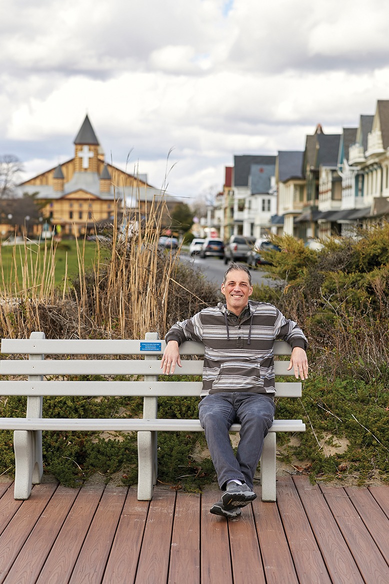 A man relaxes on a bench in Ocean Grove.