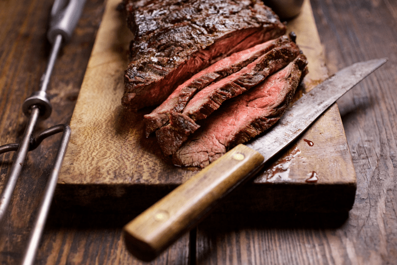 Slices of Fogo de Chão steak on cutting board