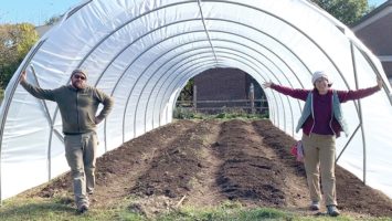 Shaun Ananko of Grow It Green Morristown stands in front of a high tunnel built above one of the organization's gardens.