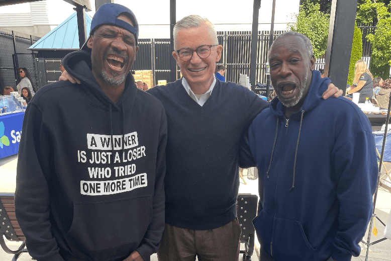 Former Gov. Jim McGreevey with two smiling supporters