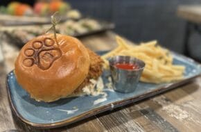 A fried chicken sandwich with a pawprint-stamped bun at Copper Dog in Wildwood