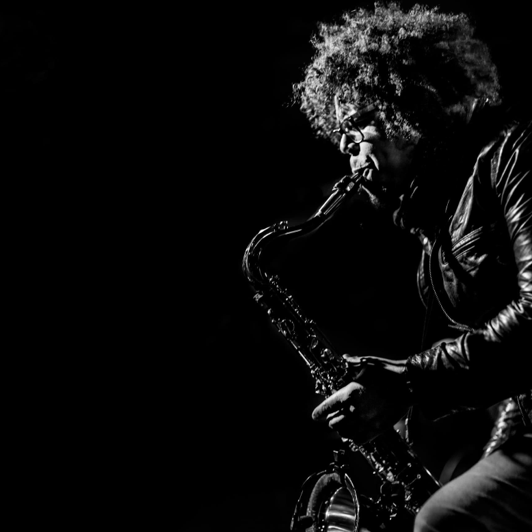 Black-and-white photo of Jake Clemons playing the saxophone