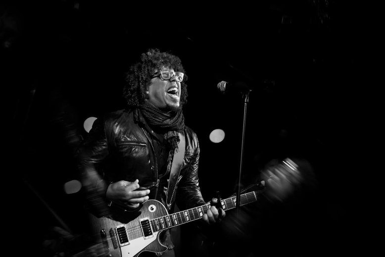 Black-and-white photo of Jake Clemons playing the guitar