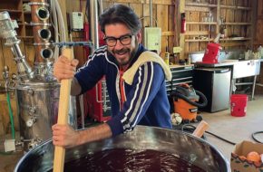 Isolation Proof founder and distiller Jake Sherry mixes a batch of pink gin.