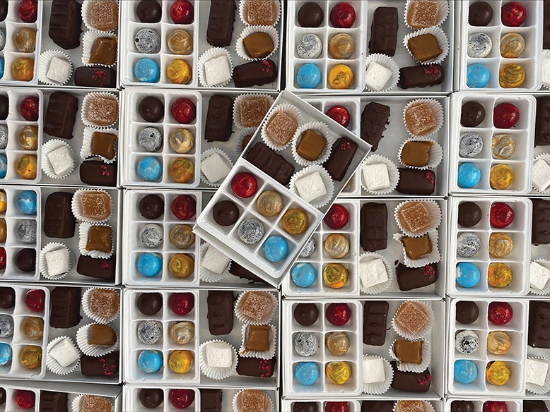 An overhead shot of dozens of chocolate treats.