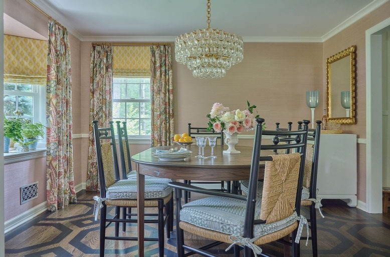 Ridgewood dining room with petal-pink walls, a hand-painted floor and black chairs