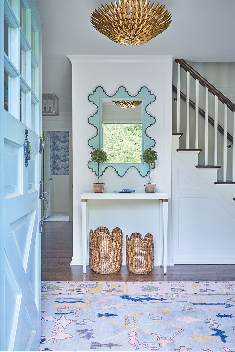 Entrance to a Ridgewood home has a baby-blue door and, inside, a wavy blue mirror
