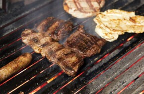 Steak and other meats on grill at La Fusta in North Bergen