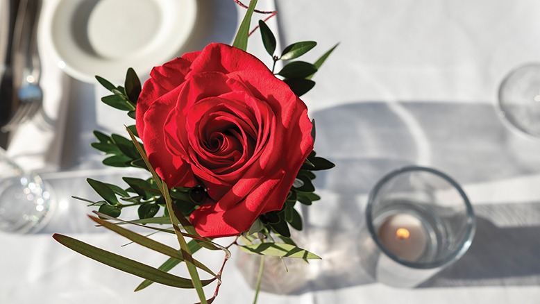 A red rose on a white table setting at Laboratorio Kitchen in Montclair.