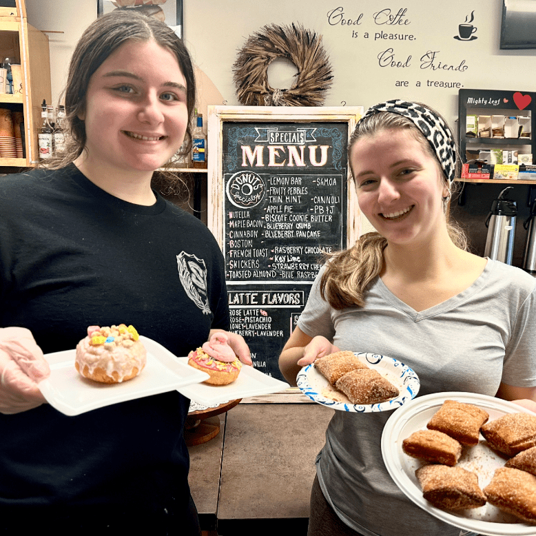 Two young girls show off treats at Beignets in Denville