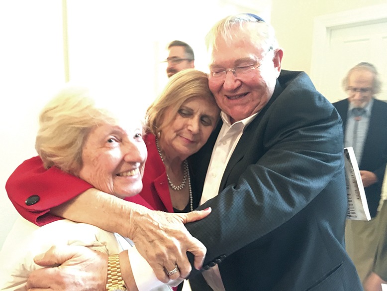 Three New Jersey–based Holocaust survivors embrace in an emotional reunion in 2017.