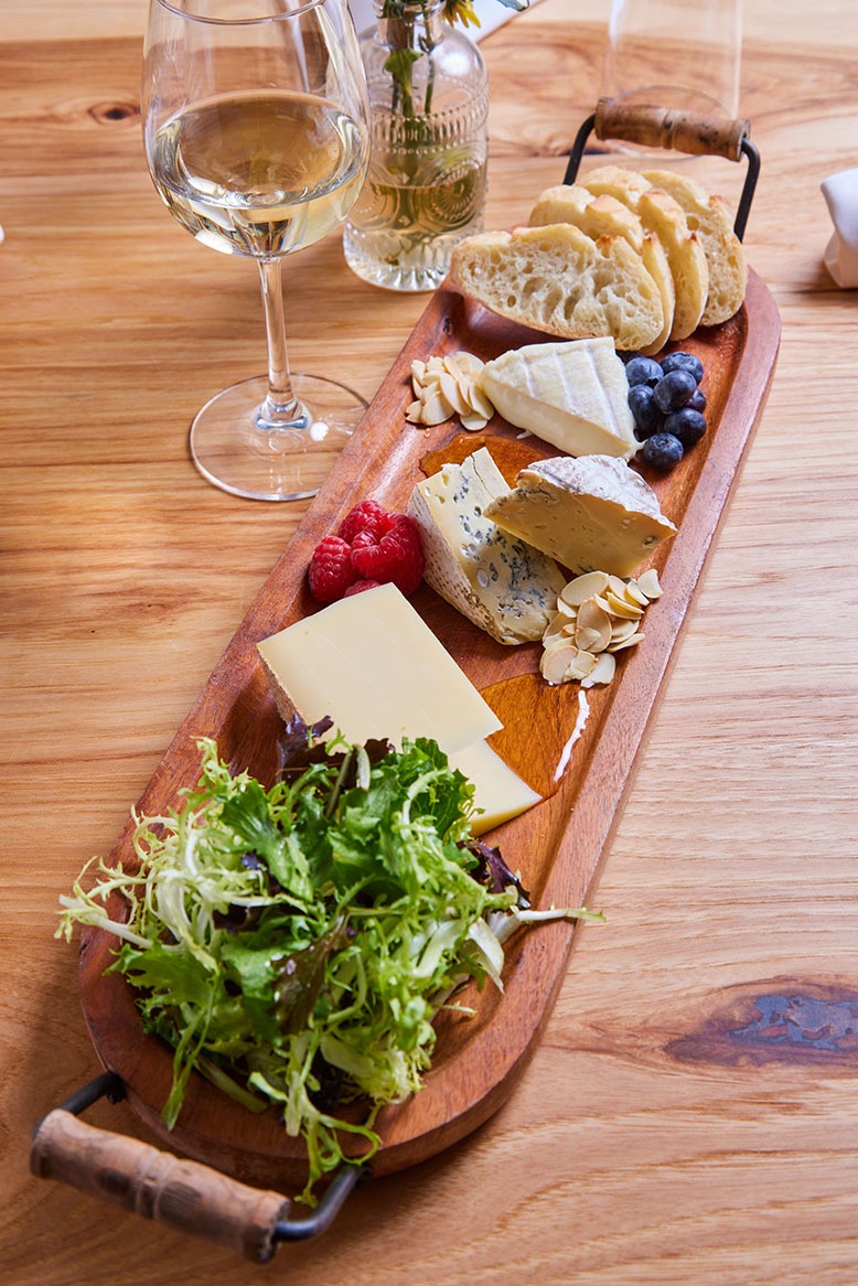 Cheeses from France alongside berry compote, honey, almonds, greens and French bread at Café le Jardin in Audubon