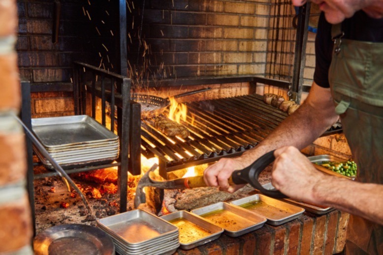 Schulte tends the wood grill at Primal in Cape May