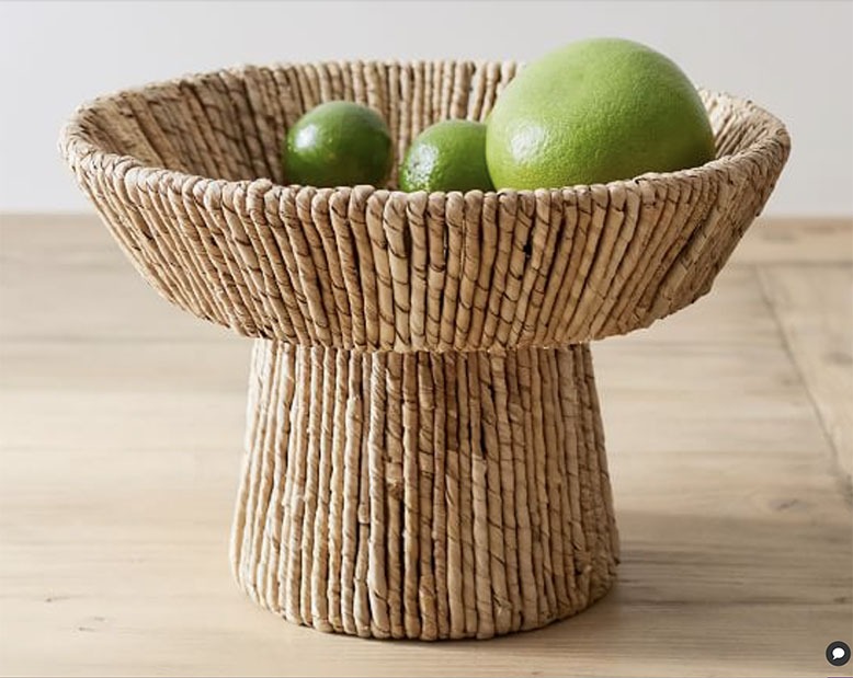 Handwoven seagrass bowl with green fruit