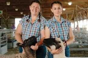 Dawn Christy Granja and daughter Emily pose with a sheep.