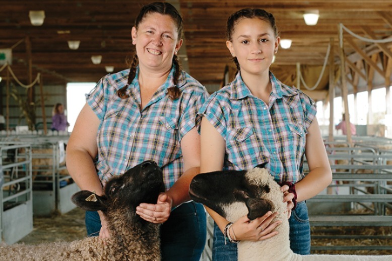 Dawn Christy Granja and daughter Emily pose with a sheep.