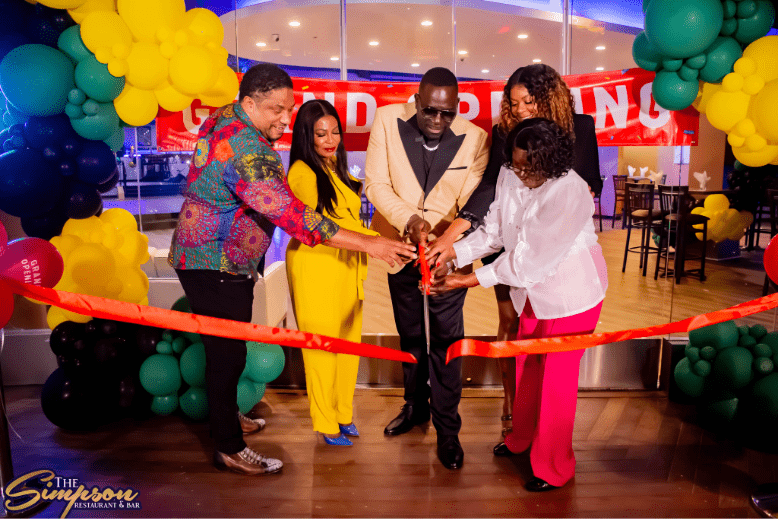 Chef Wenford Patrick Simpson cuts a ribbon to celebrate the opening of his Atlantic City restaurant alongside his mom and Alsion Wilson, New York's Consul General of Jamaica