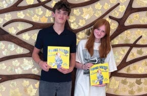 Trevor Ostfeld and Iryna Chernyak with their children's book.