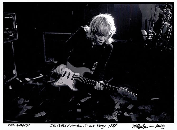 A young Warren Zanes plays on an electric guitar on stage at the Stone Pony