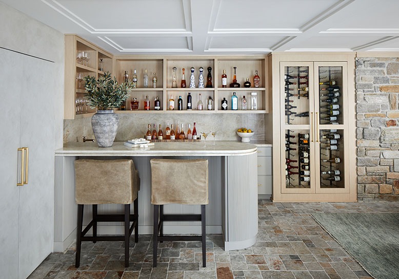 The corner bar area in the family room of a Westfield couple's newly renovated home features hands-free, motorized cabinetry and a wine fridge.