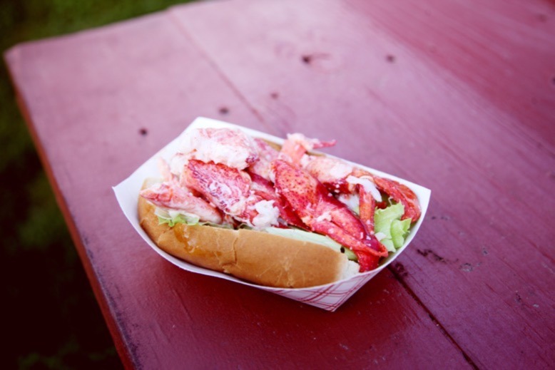 Lobster roll on red wooden table