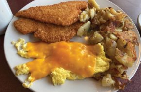 A platter of eggs with melted cheese, chicken cutlets and hash browns at Amy's Omelette House in Burlington.