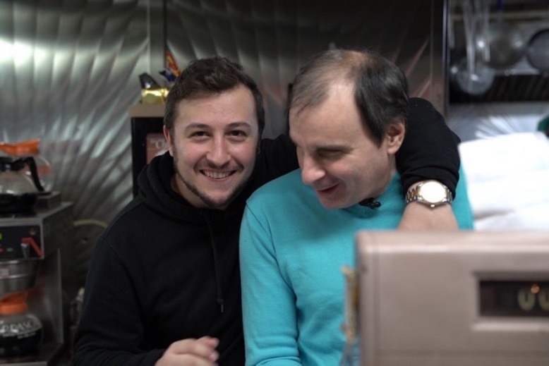 Filmmaker Anthony Scalia with his arm around blind Bendix Diner manager John Diakakis