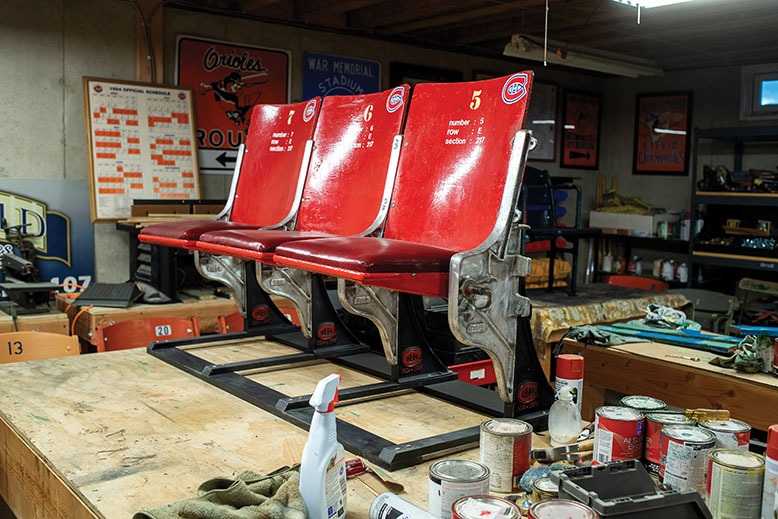Red ballpark seats in the midst of being restored in Rev. Dr. Robert W. Ralph's basement