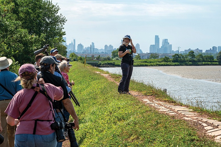 Volunteer Liana Romano leads a bird-watching walk at DeKorte Park