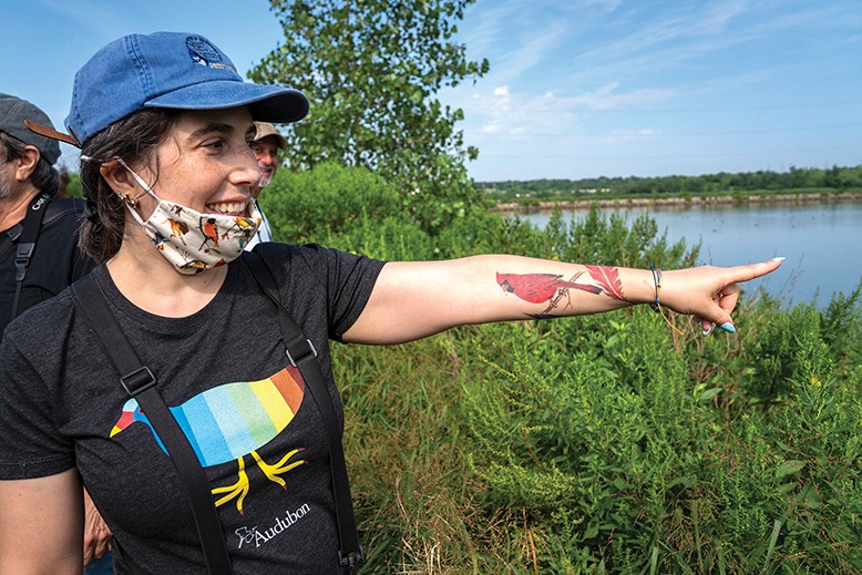 Bird lover Liana Romano shows off the cardinal tattoo on her arm.