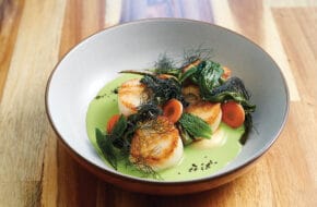 Scallops with sweet pea purée and charred spring onions at Clemmy's in Waretown