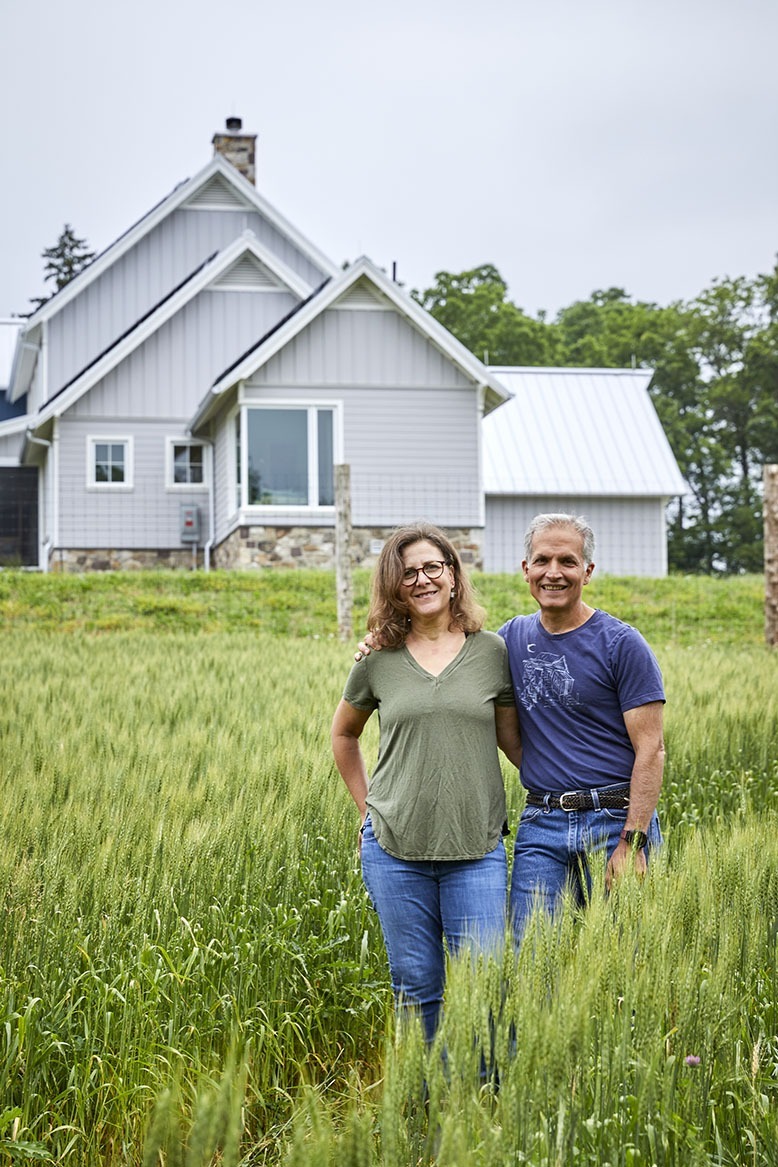 Deborah and Jason DeSalvo pose in the tall grasses outside their Hunterdon County home