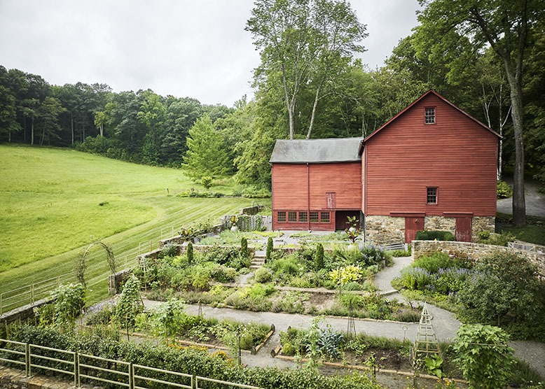 An aerial shot of Bird Haven Farm in Pottersville, which shows its classic red barns and monastery garden