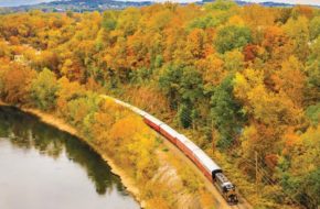 Aerial shot of the River and Steam Train amid fall foliage