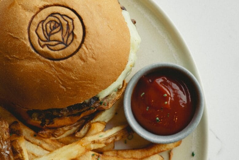 Burger with a rose stamped into its bun at The Hudson Rose in Nutley