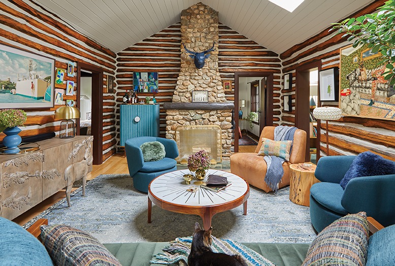 The living room of Dan and Laurence's log cabin is filled with brown and blue hues.