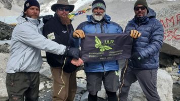 Jim Raffone and three other climbers hold a JAR of Hope banner on Mt. Everest