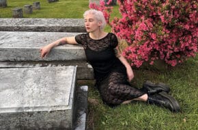 Woman in black dress in graveyard