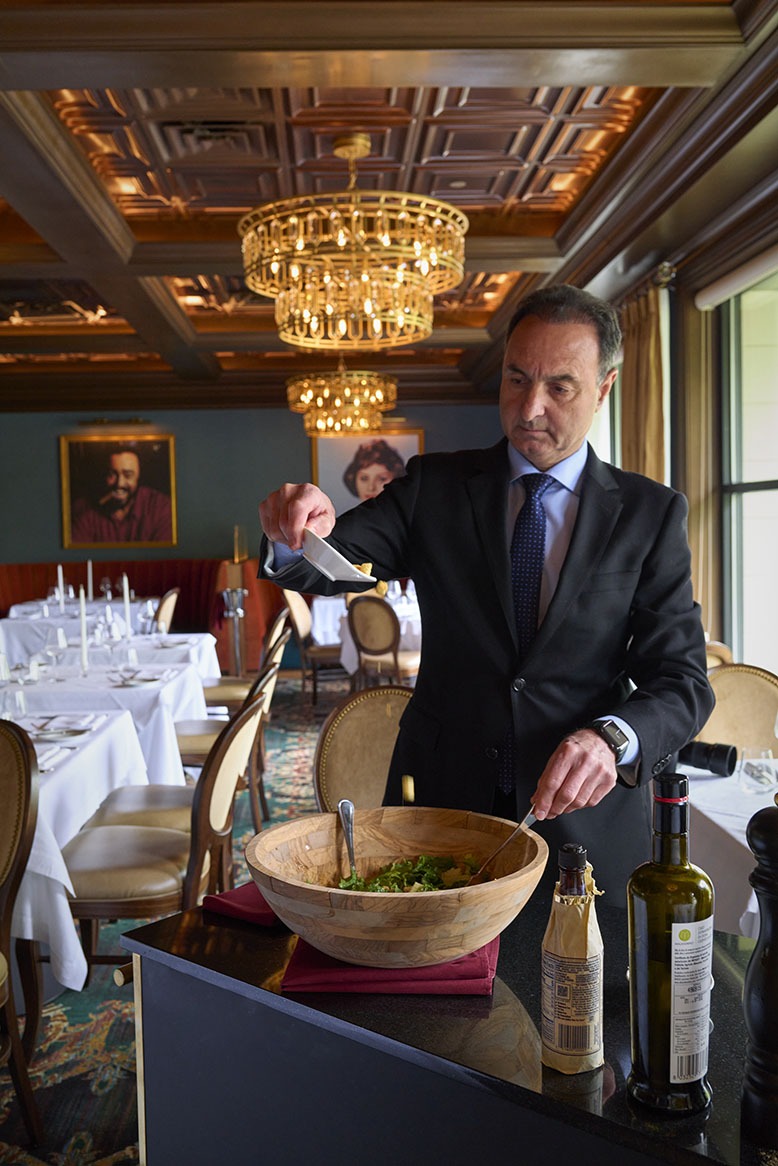 General manager Pino Algeri adds the finishing touches to the tableside Caesar salad at Ristorante Lucca in Boredntown