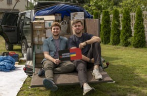 Dillon Carroll of Ridgewood and Mark Kreynovich sit in front of a car loaded with supplies for their newly formed organization, Mission to Ukraine