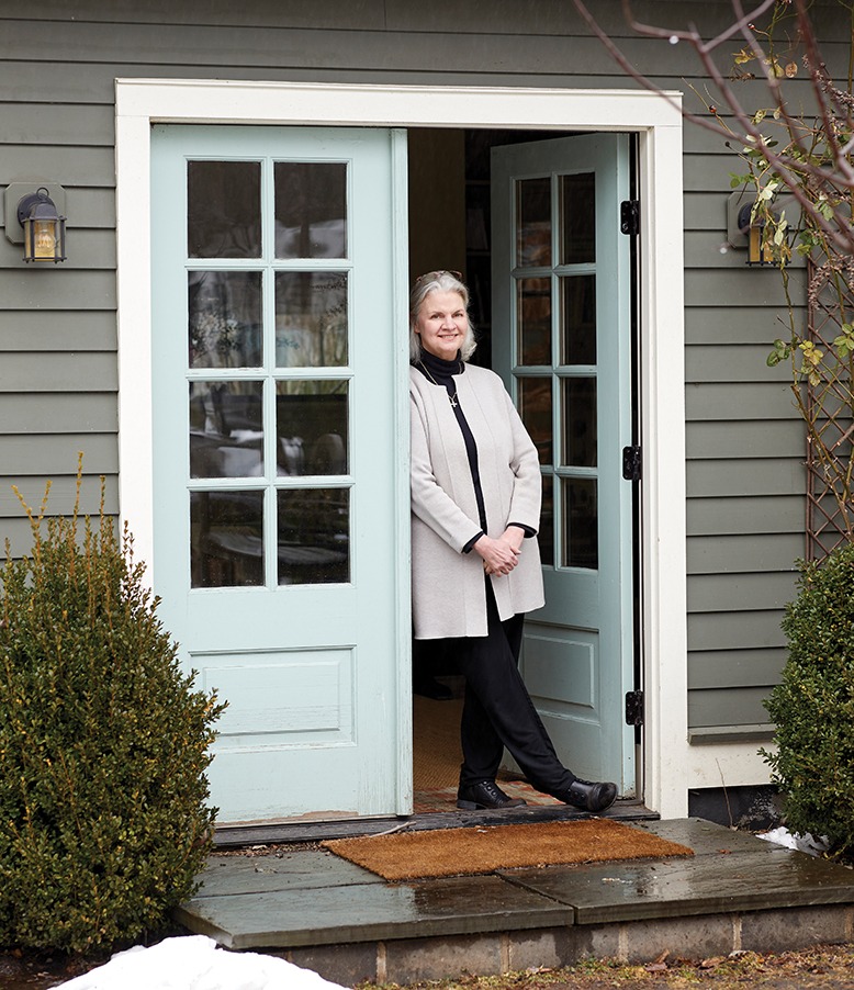 Interior designer Sally Ross stands in the doorway of her garage-turned-office.
