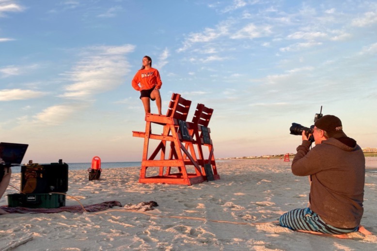 Dave Moser photographs a Jersey Shore lifeguard, who stands on a red lifeguard chair