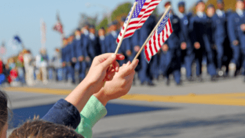 Parade with children waving American flags